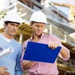 Male architects with blueprint and clipboard working at site - Architecture GOLN [ en.architecture.gurukul.edu.bd ]